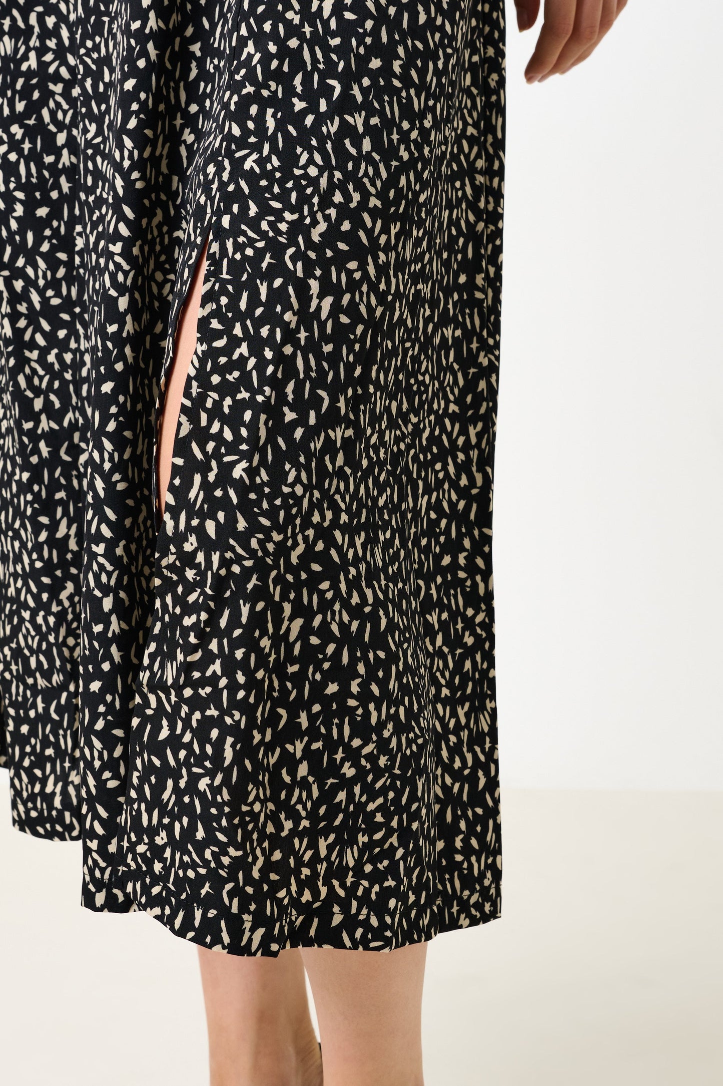 Black dress with white pattern on a white background