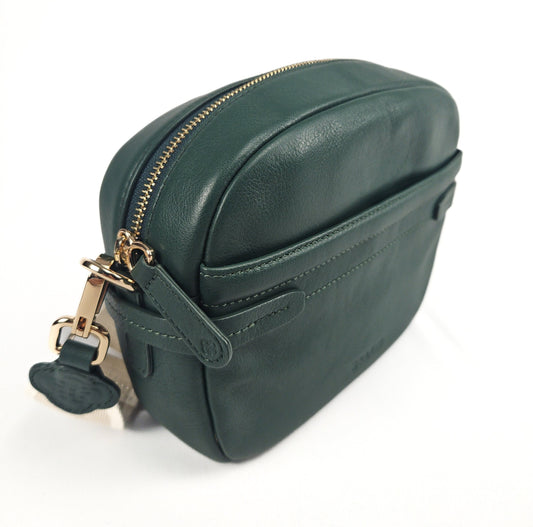 Green leather bag with gold zipper and strap on a white background