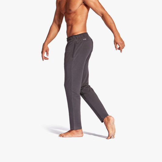 Person wearing gray sweatpants on a white background