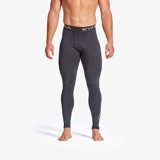 Person wearing black compression leggings with a brand logo on a white background