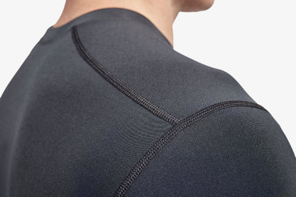 Close-up of a person wearing a dark gray athletic shirt with a focus on the shoulder area.