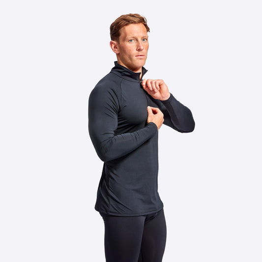 Man wearing a black athletic outfit on a light gray background