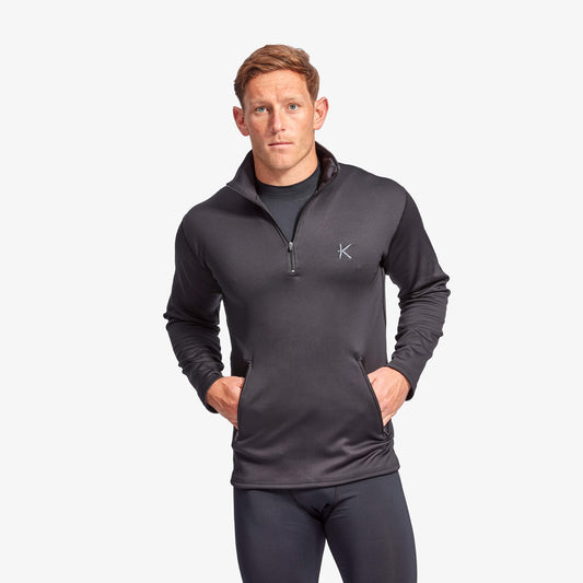 Man wearing a dark gray pullover with a logo on a white background