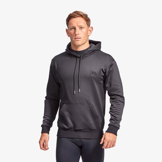 Man wearing a dark gray hoodie on a white background