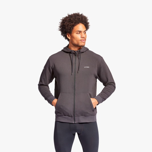 Man wearing a gray hoodie with a brand logo on a white background