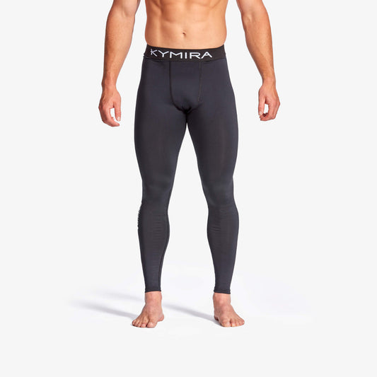 Person wearing black compression leggings with 'Kymira' branding on a white background