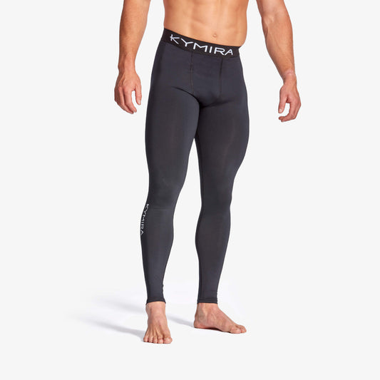 Person wearing black leggings with Kymira branding on a white background