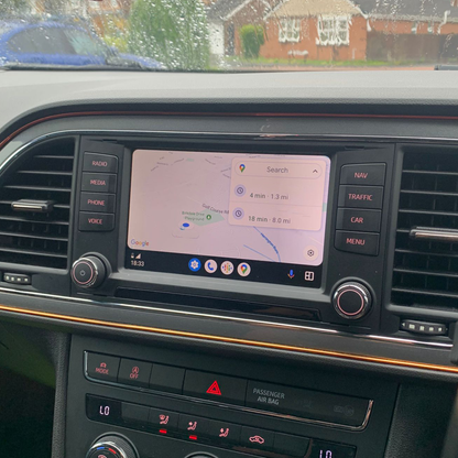 Car dashboard with navigation screen displaying a route map.