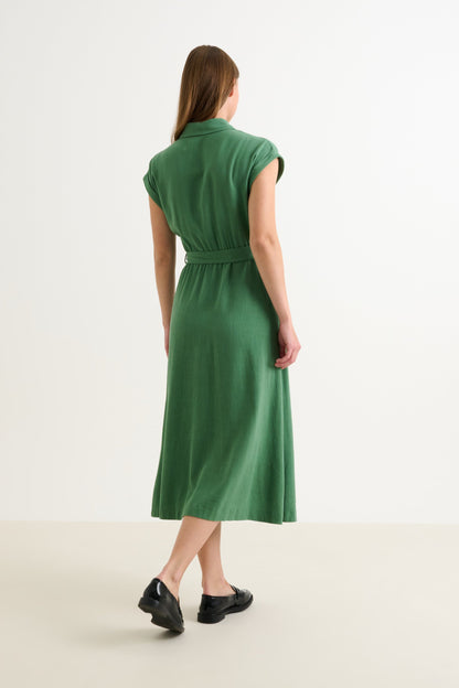 Woman wearing a green dress on a white background