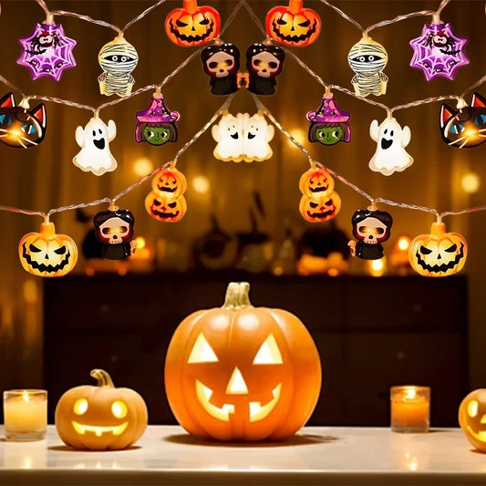 Halloween-themed string lights with pumpkins and ghosts on a table with candles.