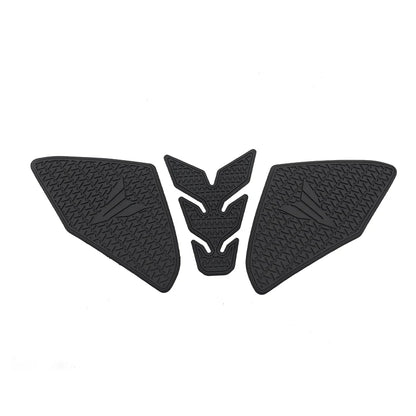 Three black motorcycle tank pads with a central emblem on a white background