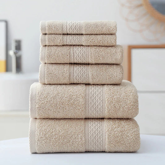 Stack of beige towels on a white surface with a blurred background