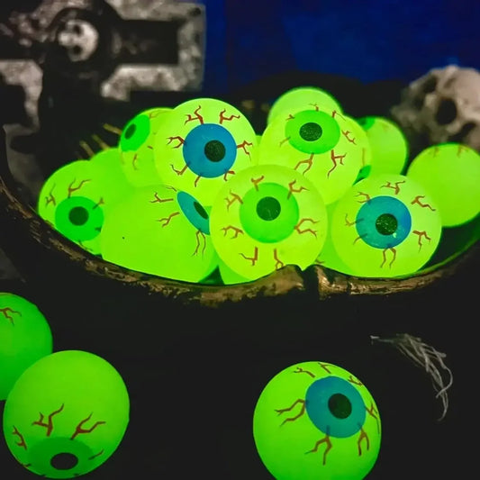 Green eyeball-shaped objects with blue centers on a dark background