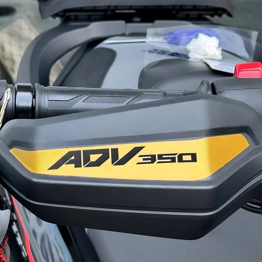 Close-up of a motorcycle handlebar with 'ADV 350' branding.