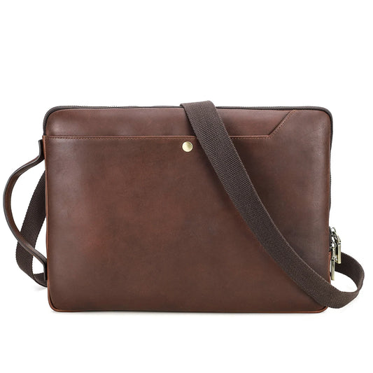 Brown leather bag with a shoulder strap on a white background