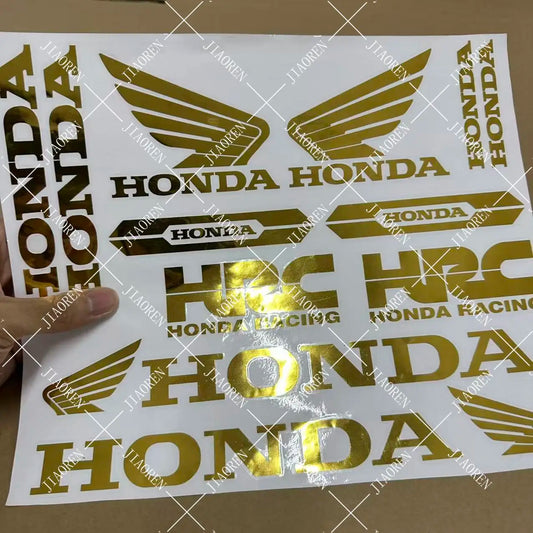 Sheet of gold Honda decals with various Honda logos on a white background.