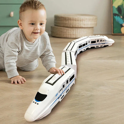 Child playing with a toy train set on a wooden floor