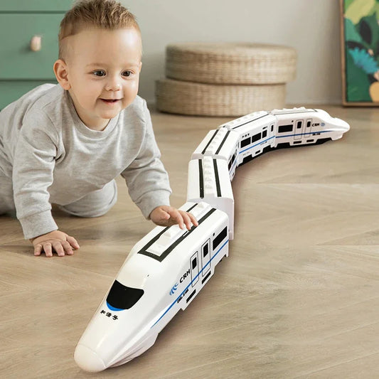 Child playing with a toy train set on a wooden floor