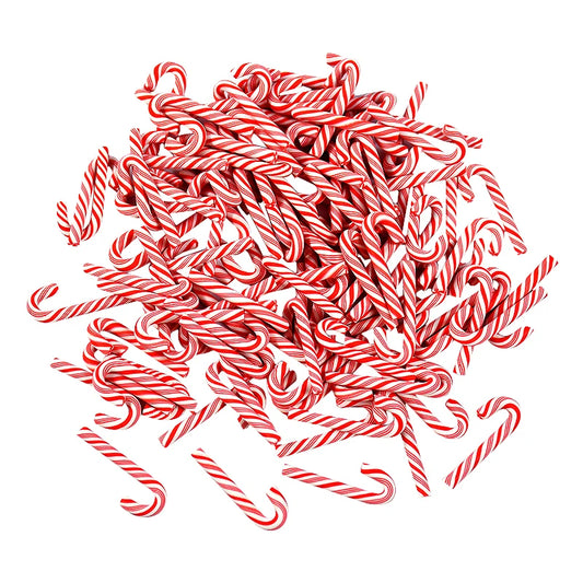 Pile of red and white candy canes on a white background