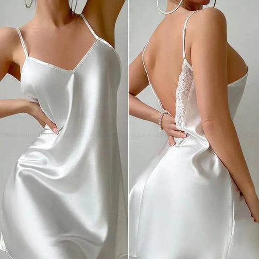 White satin slip dress with lace details on a plain background