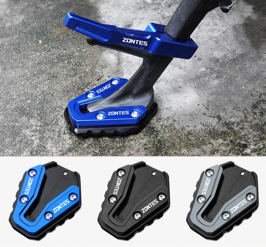 Blue and black motorcycle foot pegs with 'ZONTES' branding on a concrete surface.
