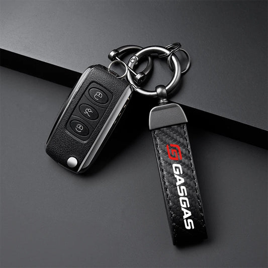Key fob with a 'Gasgas' branded keychain on a dark background
