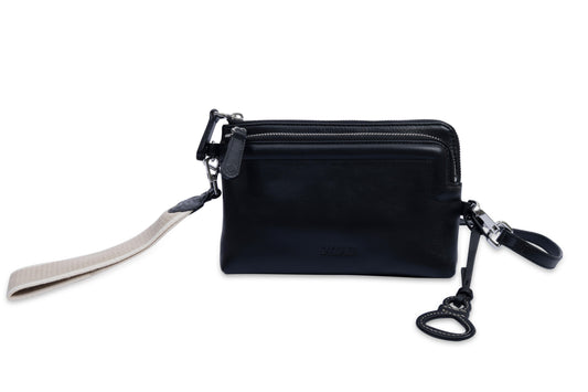 Black leather wristlet with strap and keychain on a white background