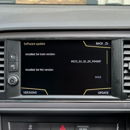 Car dashboard with a digital display showing software update information.