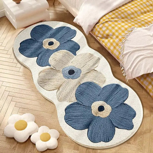 Floral-patterned rug with blue and beige flowers on a wooden floor.