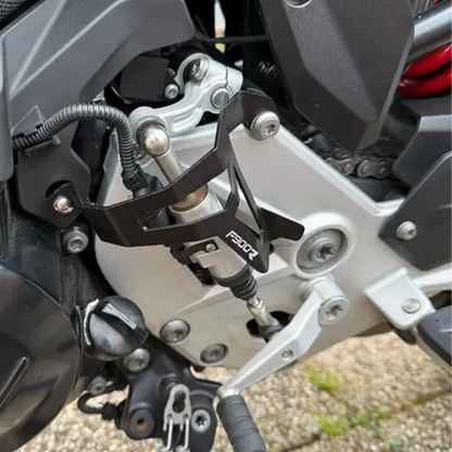 Close-up of a motorcycle's suspension system with visible branding.