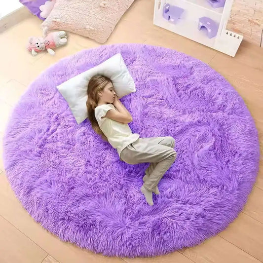 Person lying on a large purple round rug in a room with toys and decor.