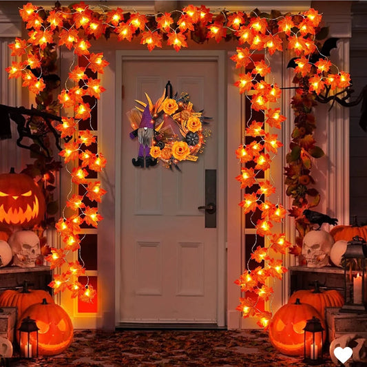 Halloween-themed door decoration with lights, pumpkins, and wreath.