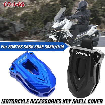 Motorcycle accessories key shell cover with ZONTES branding on a blurred background of a rider on a motorcycle.