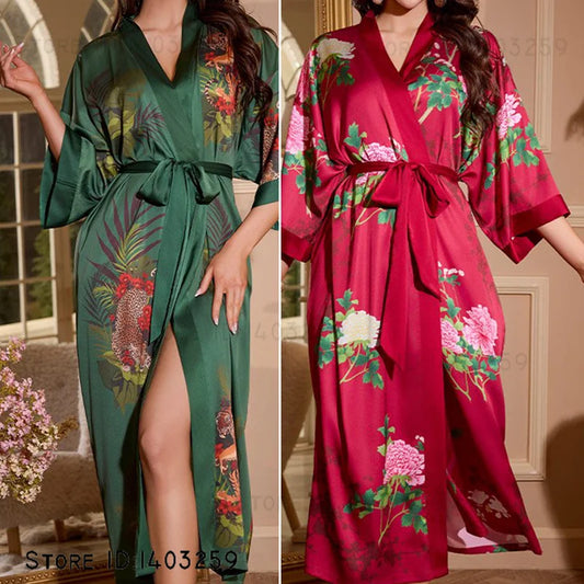 Two women wearing floral-patterned robes, one green and one red, in a home setting.