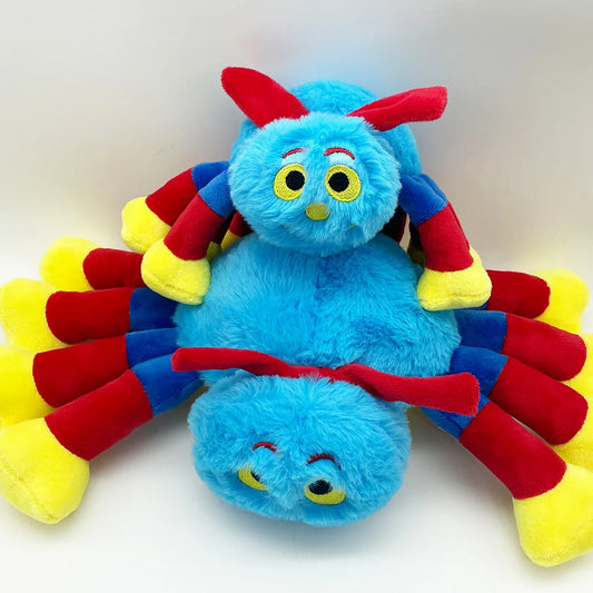 Colorful plush toy with blue body, red and yellow appendages on a white background