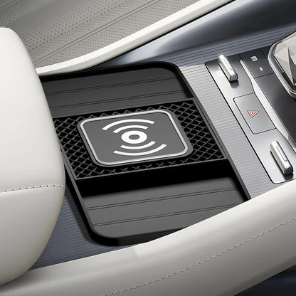 Wireless charging pad in a car's cup holder with a Wi-Fi symbol.