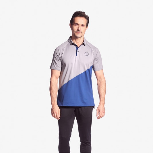 Man wearing a gray and blue polo shirt on a white background