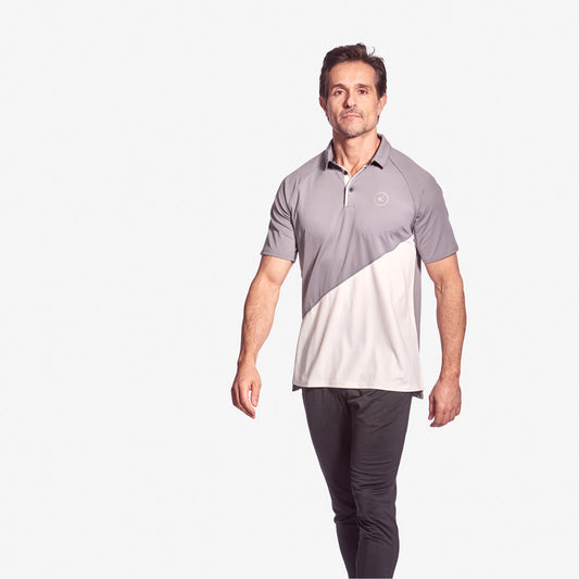 Man wearing a two-tone gray and white polo shirt on a white background