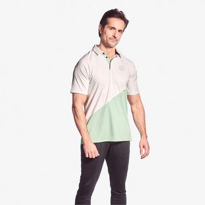 Man wearing a two-tone polo shirt with a white and green design on a white background