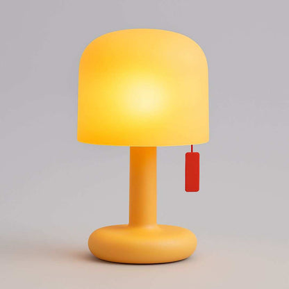 Yellow table lamp with a red tag on a gray background