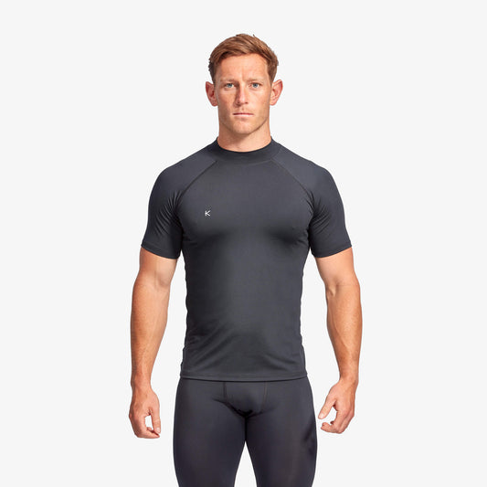 Man wearing a black athletic outfit on a white background