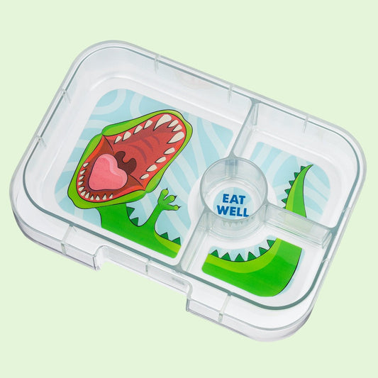 Children's lunchbox tray with dinosaur design on a light green background
