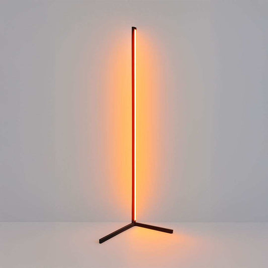 Modern floor lamp with a vertical light source on a plain background