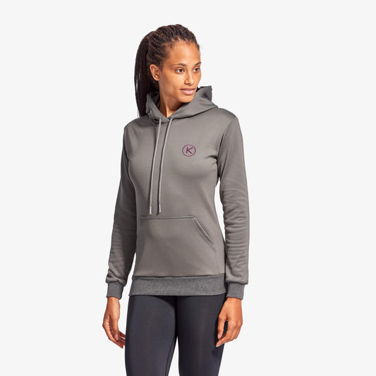Woman wearing a gray hoodie with a logo on a white background