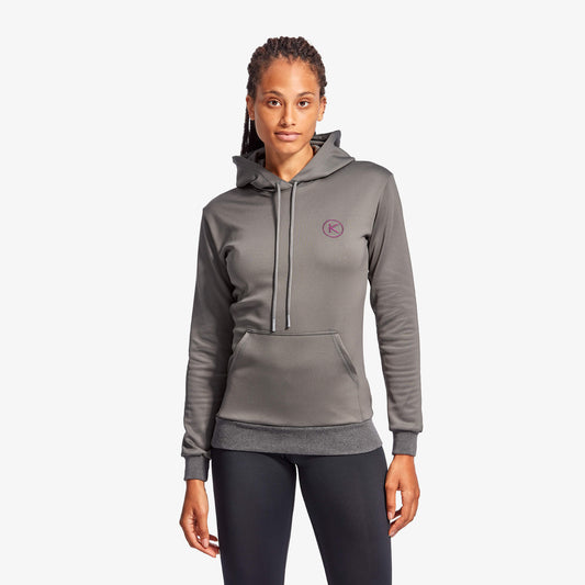 Woman wearing a gray hoodie with a logo on a white background