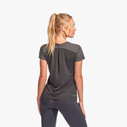 Woman wearing a black athletic outfit on a white background