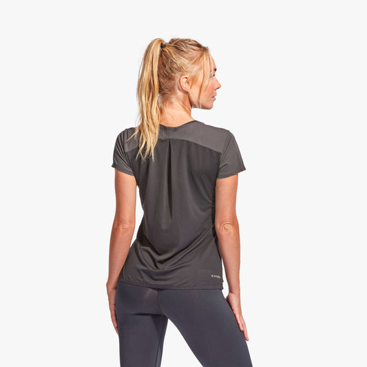 Woman wearing a black athletic outfit on a white background