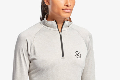 Person wearing a gray long-sleeve shirt with a brand logo on a white background