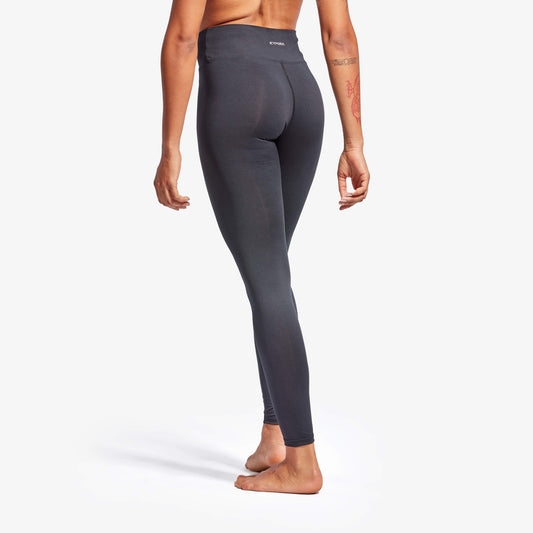 Person wearing dark gray leggings on a white background