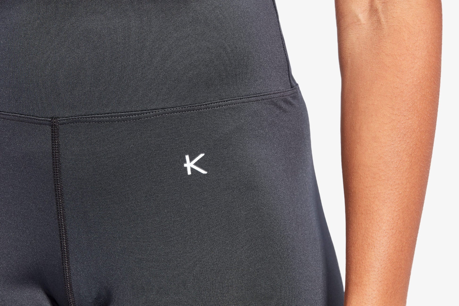 Black athletic outfit with a logo on a plain background